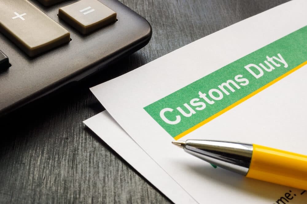 Customs duty document with calculator and pen